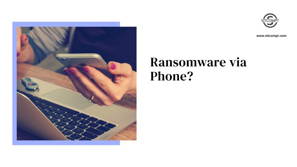 A user holding a phone and sitting in front of a Laptop.